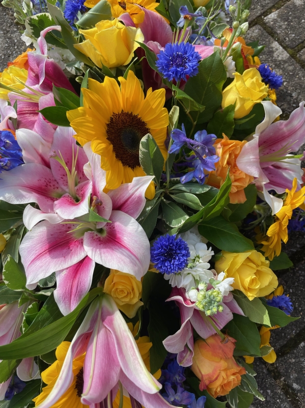 Sunflowers and lilies casket spray